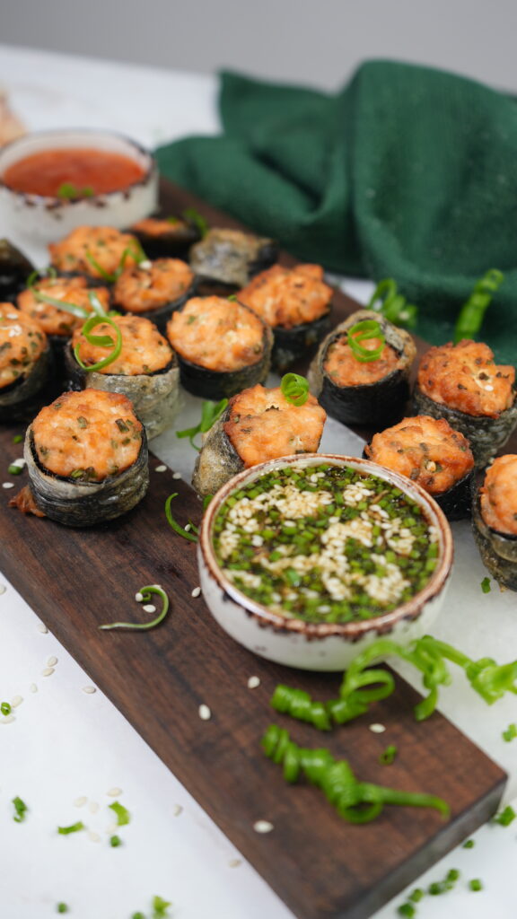 Crispy salmon bites wrapped in nori and rice paper, served with dipping sauces