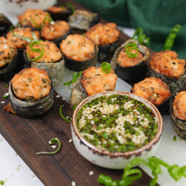 Crispy salmon bites wrapped in nori and rice paper, served with dipping sauces