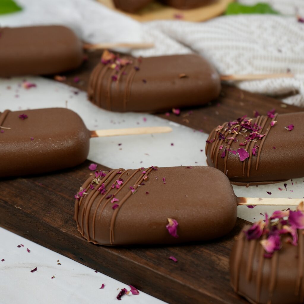 Frozen blueberry ricotta pops arranged on a tray.