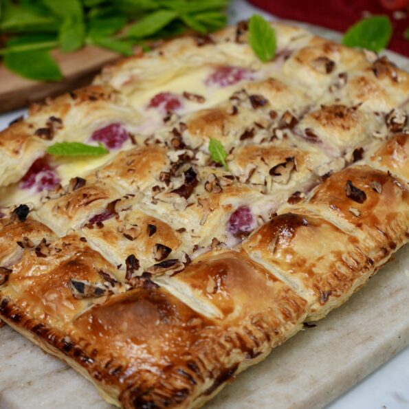 Creamy raspberry bites with golden puff pastry and a hint of custard.