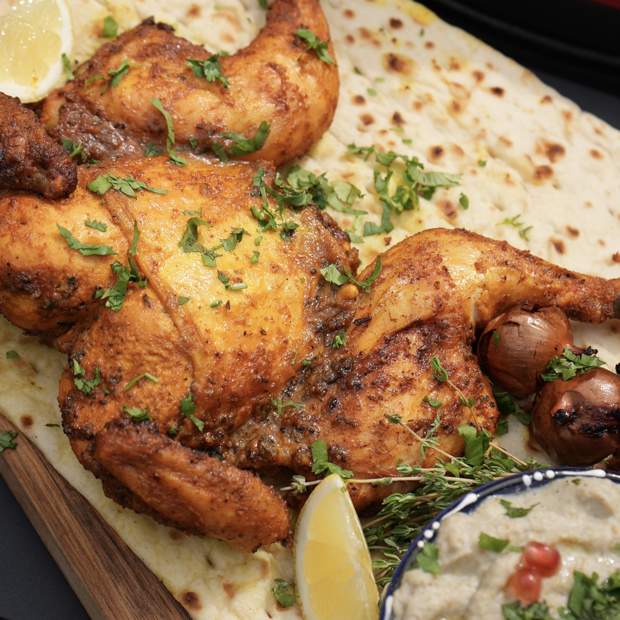 Lime and Turmeric Spatchcock Chicken served with baba ganoush.