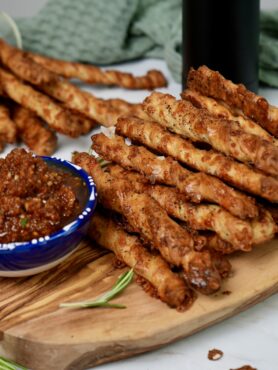 Freshly baked peppery cheesy breadsticks with dip