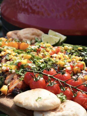 Grilled chipotle chicken served with mango salsa, warm pita bread, and grilled vegetables.