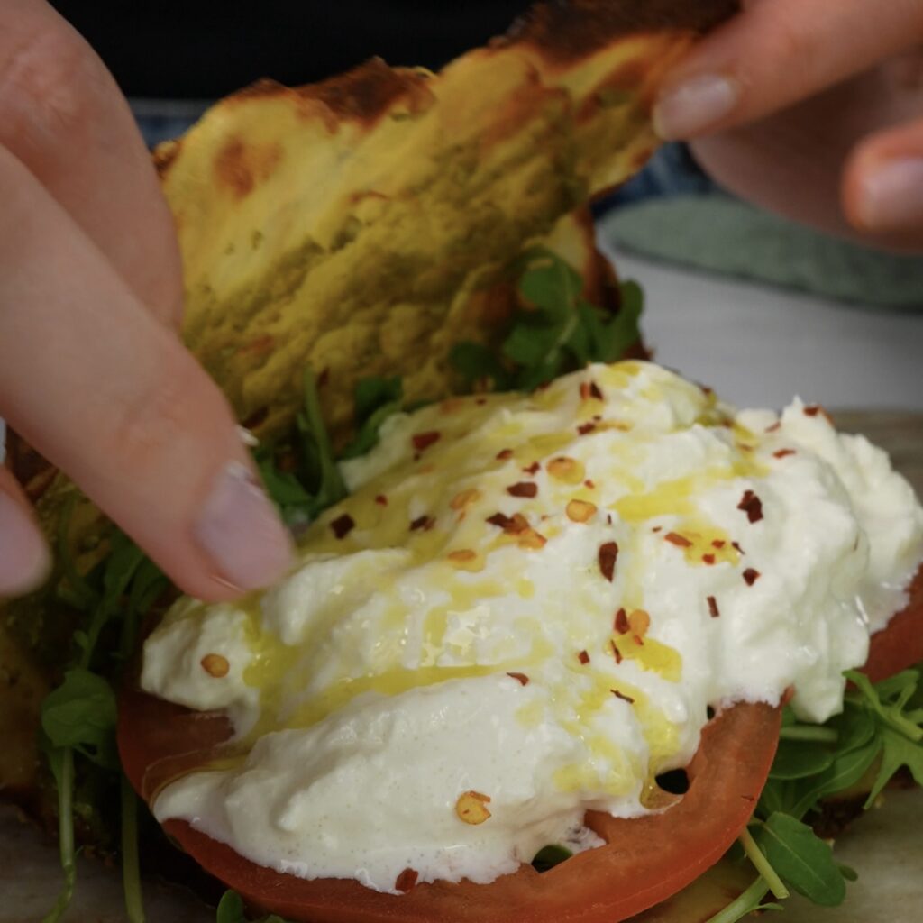 Folding a crispy potato crust over the filling to form a wrap.