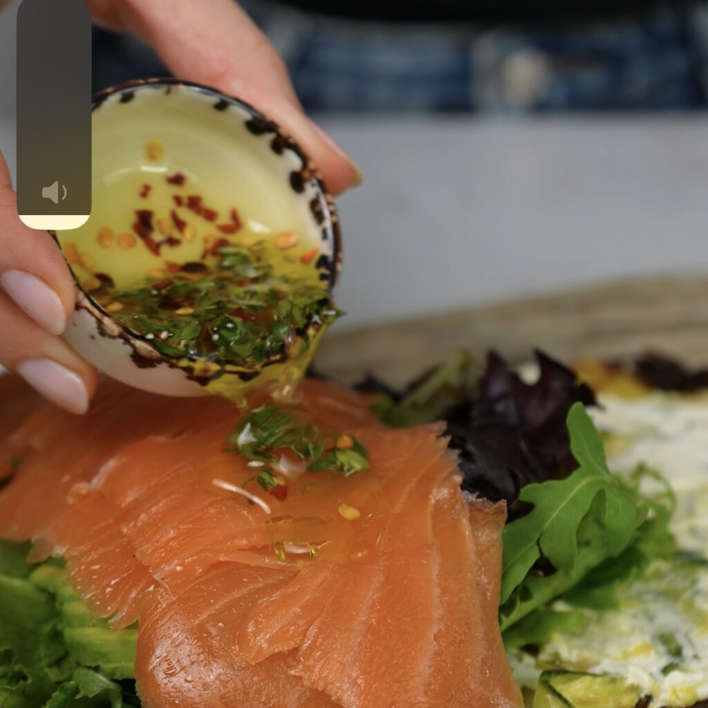 Olive oil mixture drizzled over smoked salmon on courgette wrap