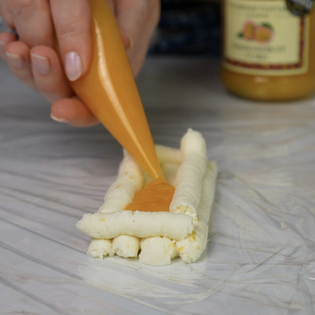 Filling the ricotta trough with passion fruit curd.