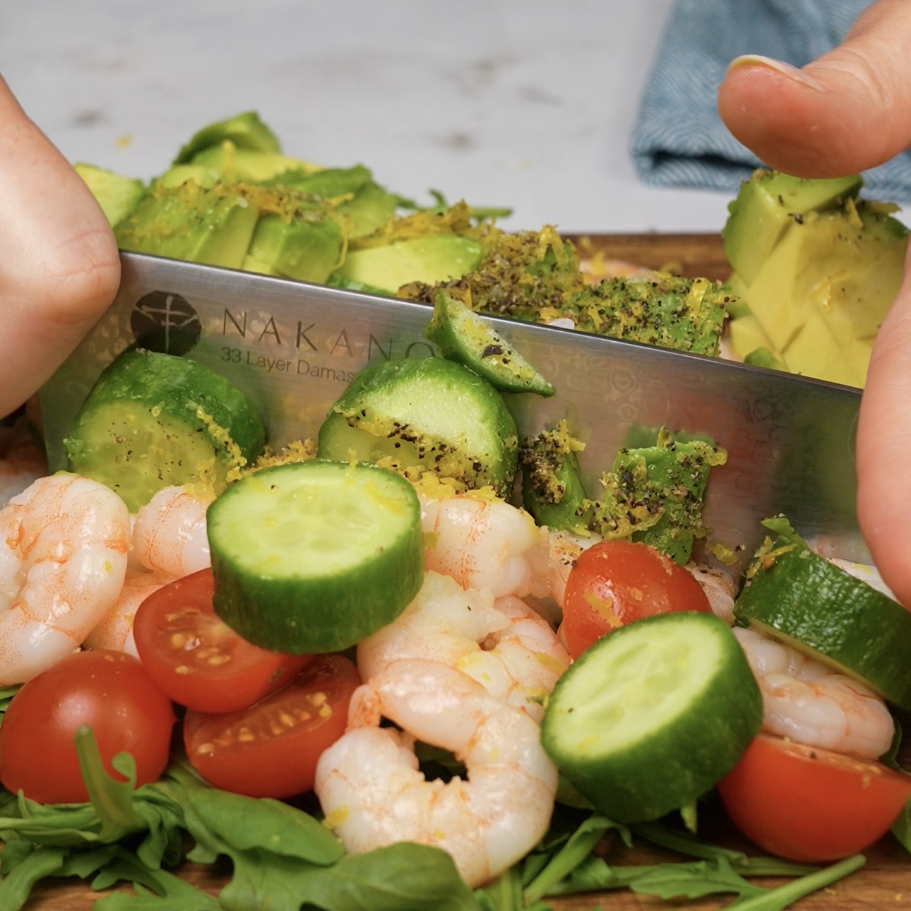 Chopping vegetables and shrimp for the spinach chopped salad roll.