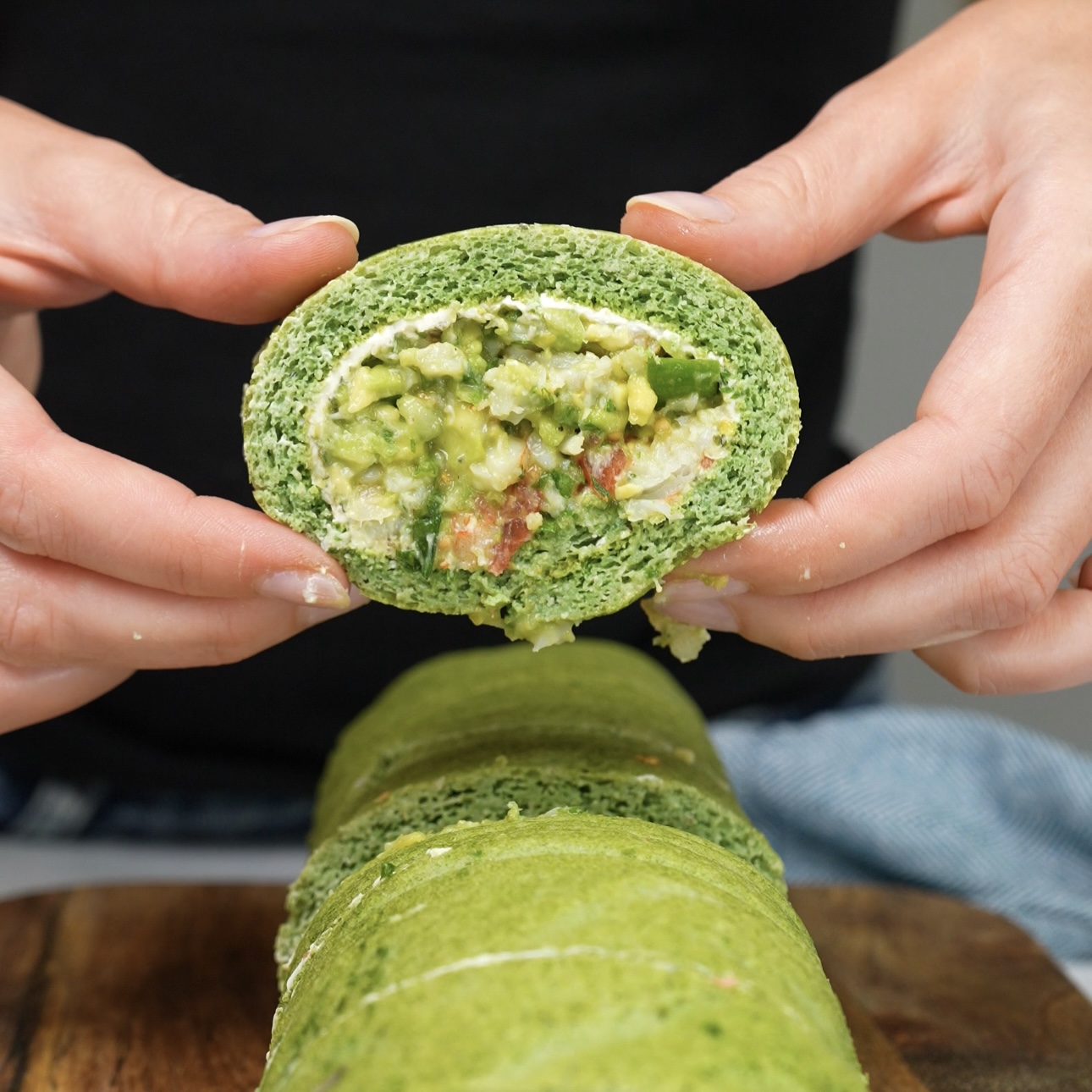 Sliced piece of Spinach Chopped Salad Roll showing the vibrant filling.