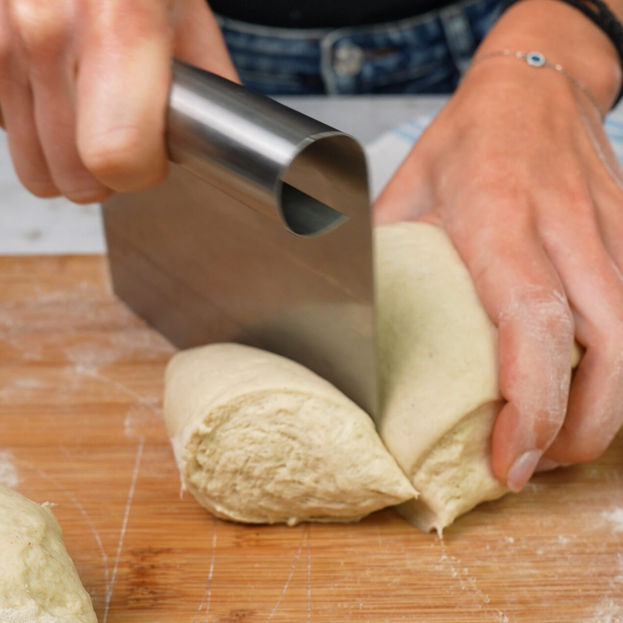 Dough divided into eight equal parts on a floured surface.