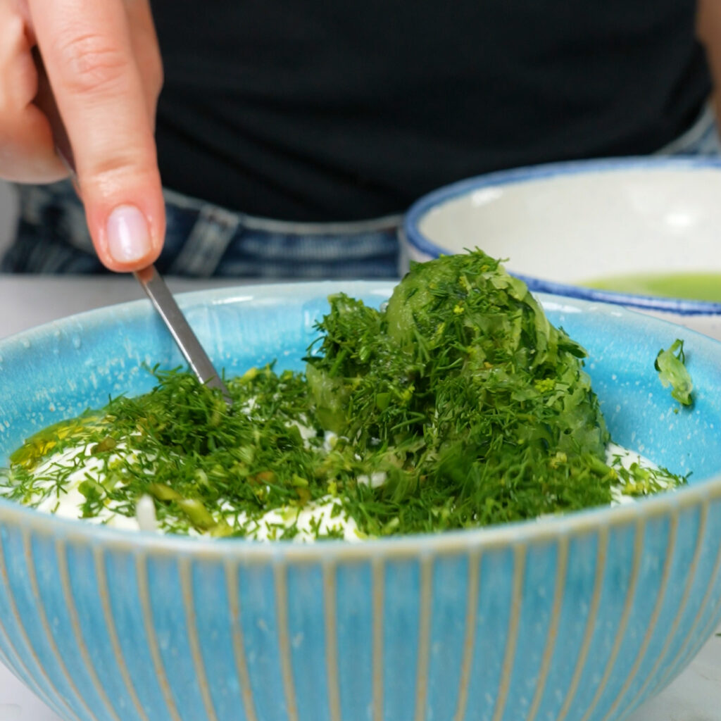 Mixing tzatziki ingredients for Greek Chicken Souvlaki