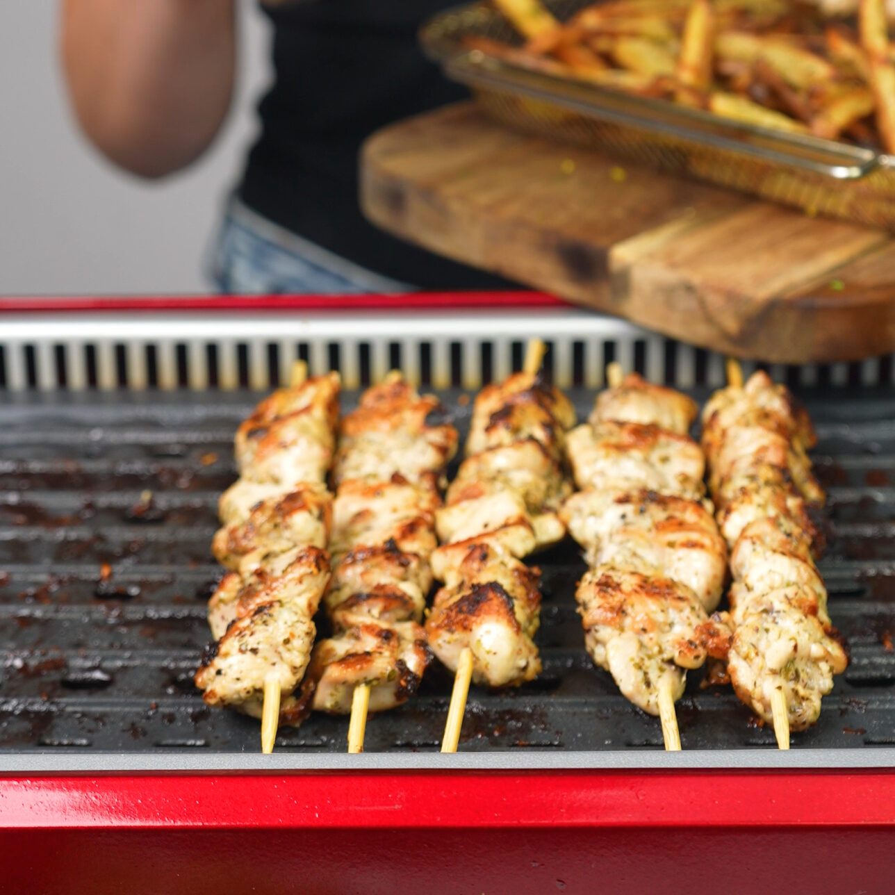 Chicken skewers cooking on the grill for Greek Chicken Souvlaki