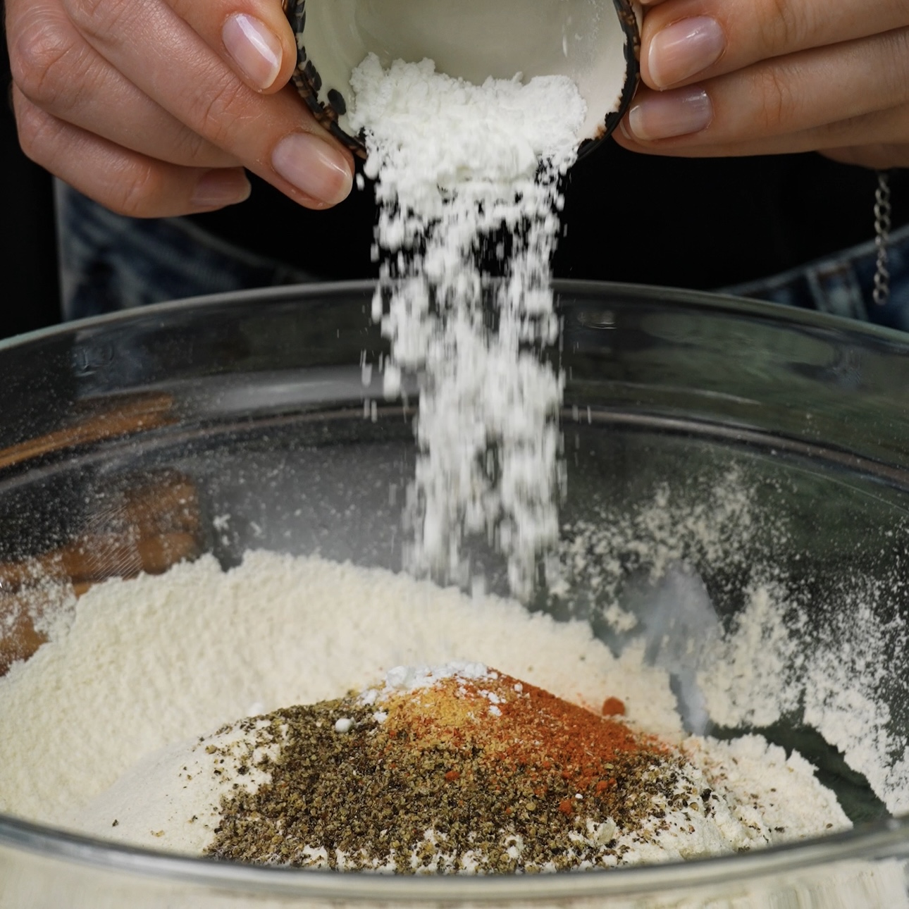 Adding ingredients to a mixing bowl for breadsticks.