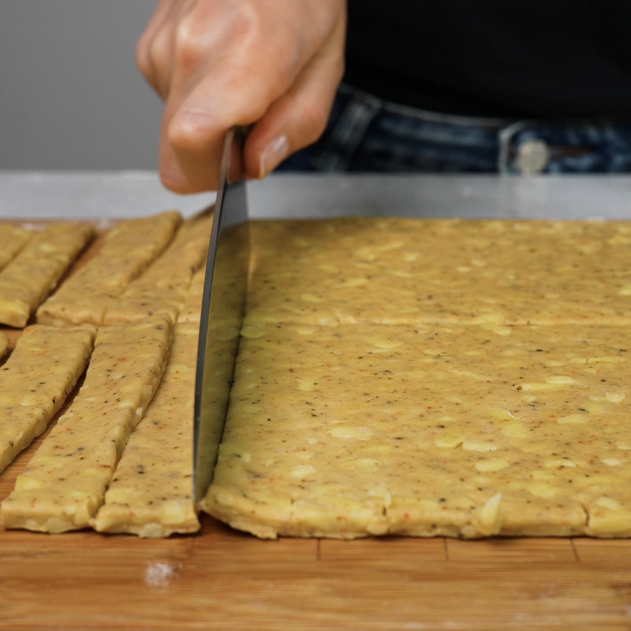 Dough cut into 2 cm strips, with each strip further divided into halves