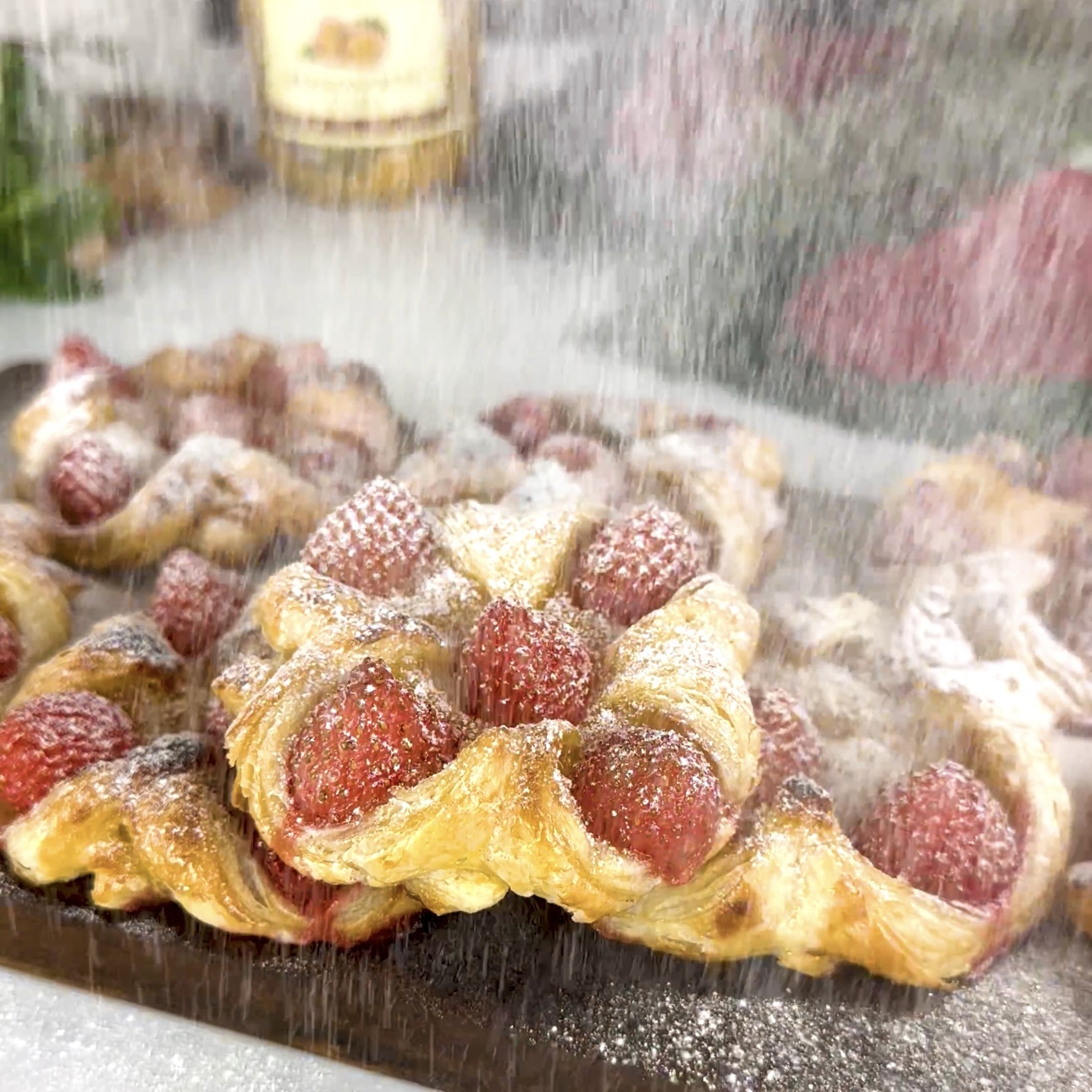 Dusting baked Passion Fruit Curd and Strawberry Puffs with icing sugar.