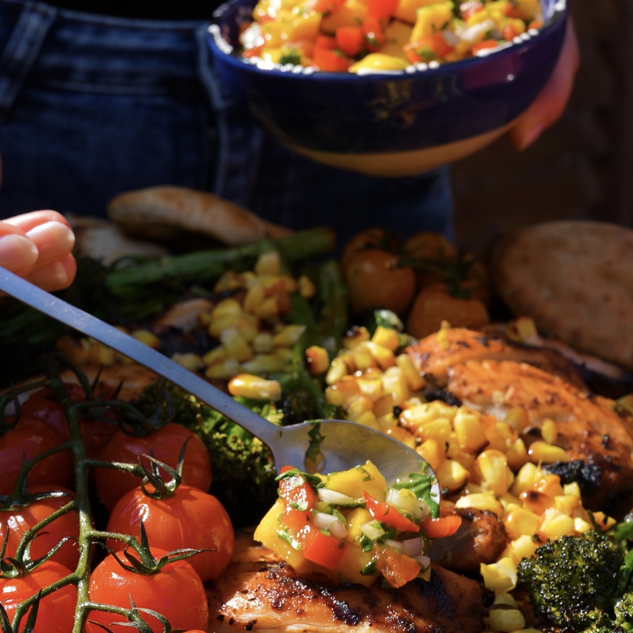 Sliced grilled chicken served with grilled vegetables, warm pita bread, chipotle mayo, and mango salsa.