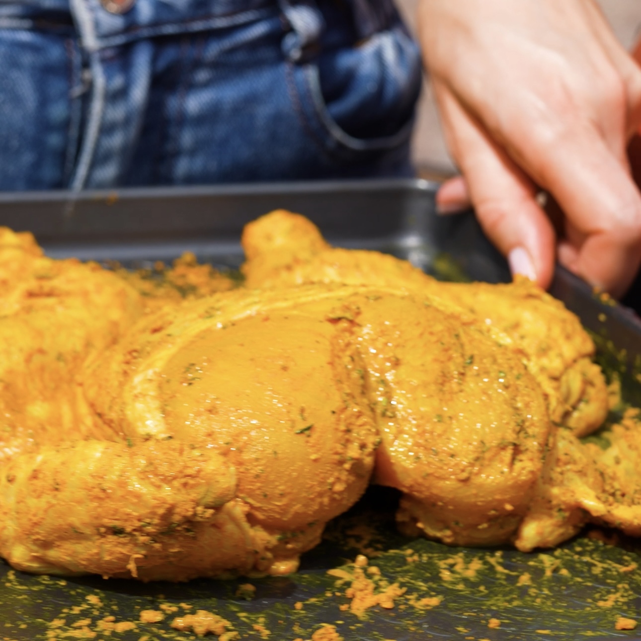 Chicken coated with a mixture of spices and herbs for theLime and Turmeric Spatchcock Chicken with Baba Ganoush recipe