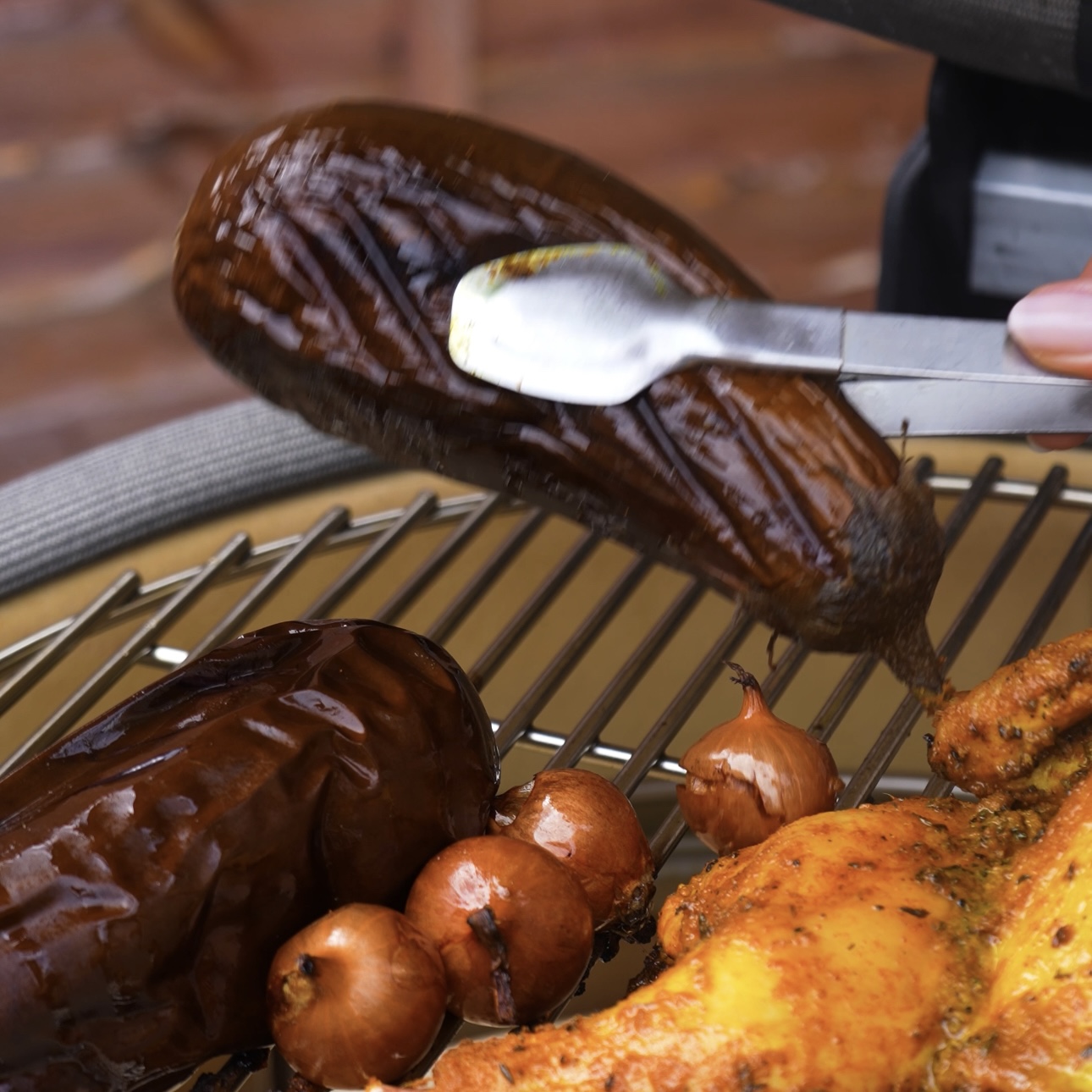 Removing aubergines from the grill.