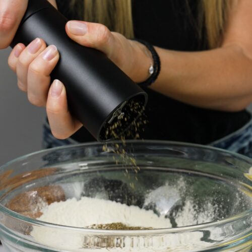 Grinding black pepper with a MANNKITCHEN Pepper Cannon.