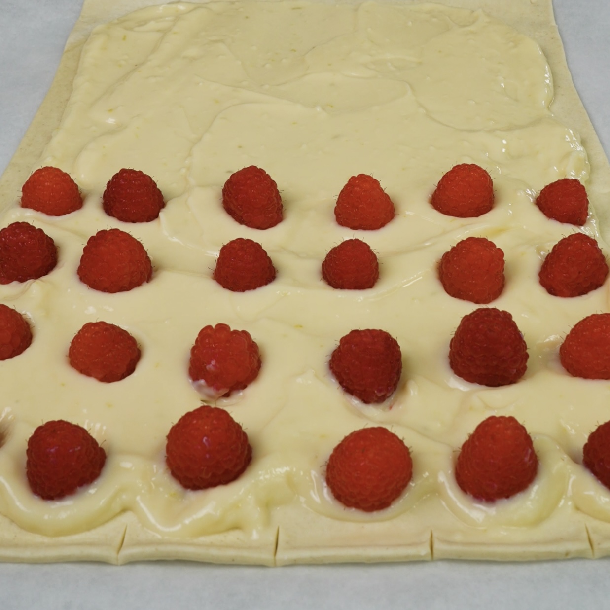 Fresh raspberries placed on top of creamy custard.