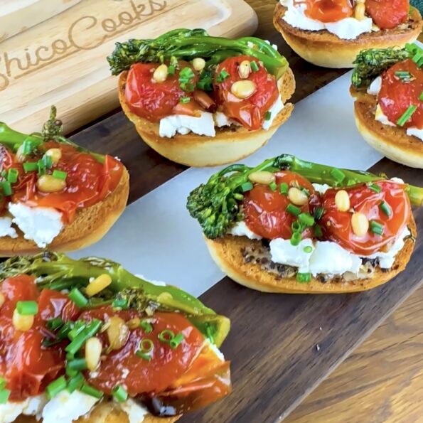 Roasted tomato and goat cheese toast topped with sautéed broccoli, pine nuts, and chopped chives.