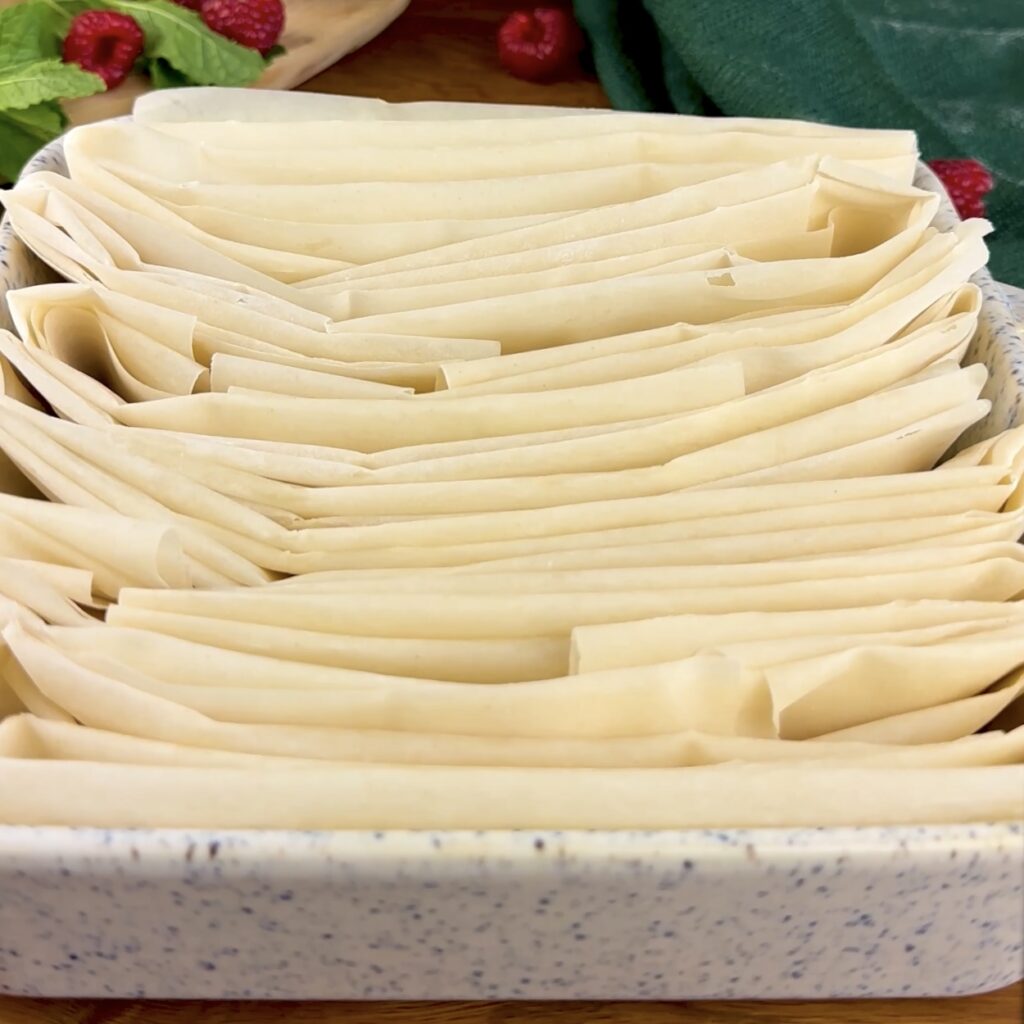 Filo pastry arranged in a baking dish in a ruffled pattern 