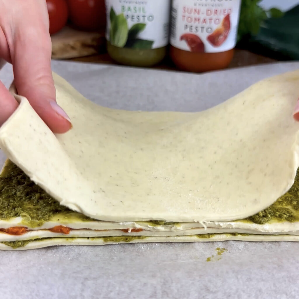 All layers of pesto covered with the final layer of puff pastry.