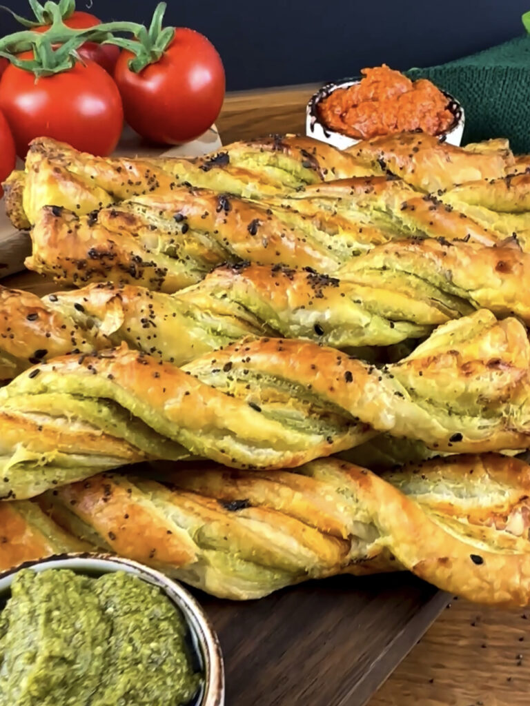 Golden Pesto Twists with a crispy texture and sprinkled with sesame seeds.