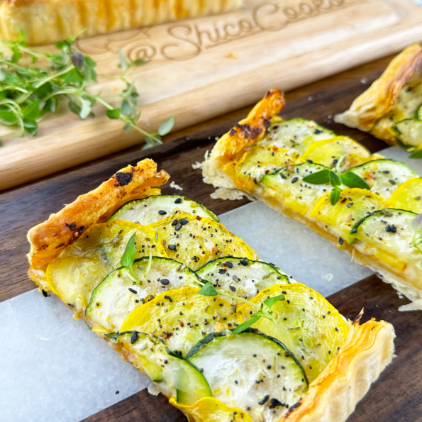 A Courgette Sun-dried Tomato Pesto Tart topped with sliced courgettes