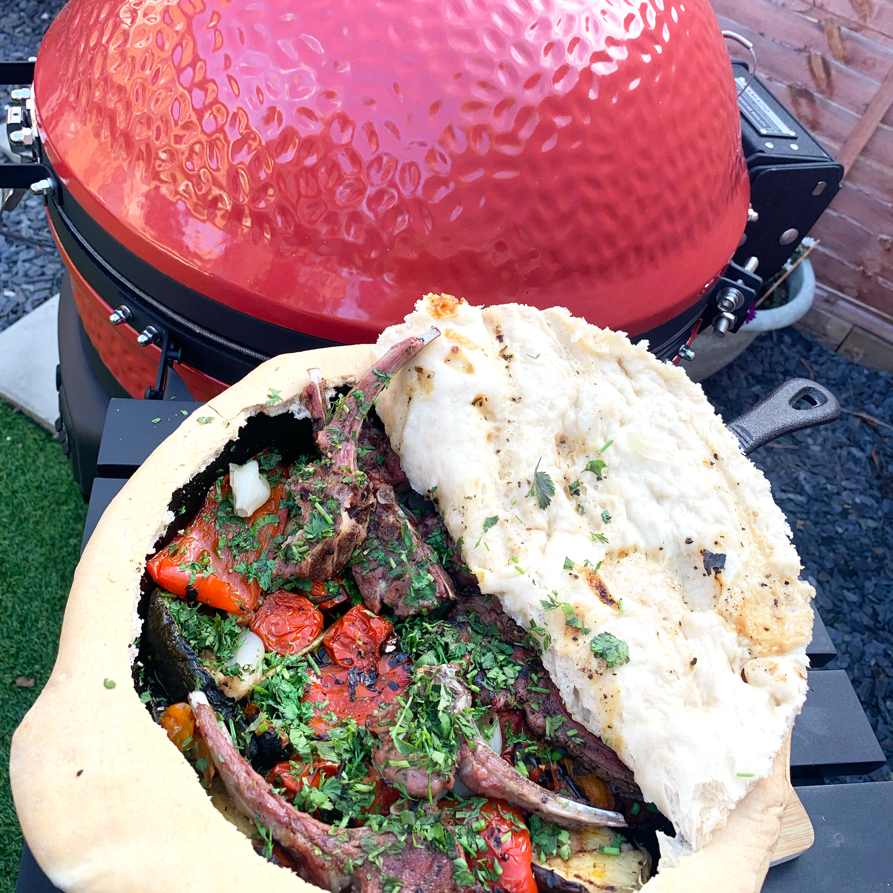 Finished dish of lamb chops and vegetables, garnished with fresh chopped coriander.