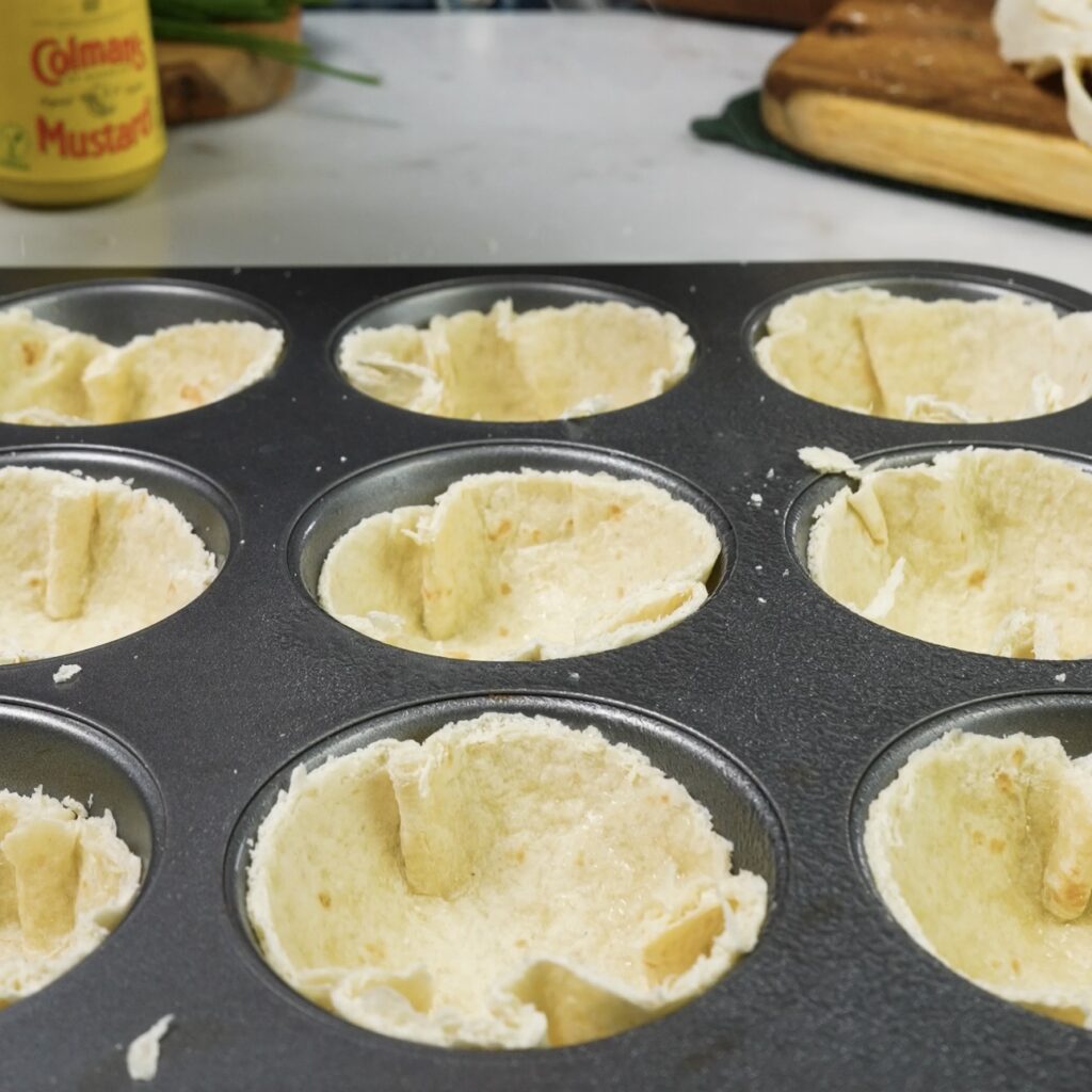 Tortilla rounds shaped into cups using a muffin tin.