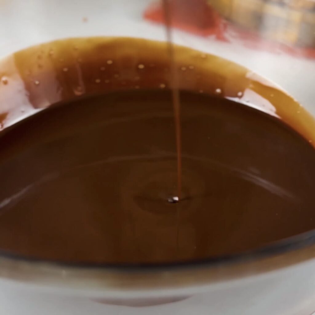 Melted chocolate and butter mixture in a bowl for Fudgy Brownies