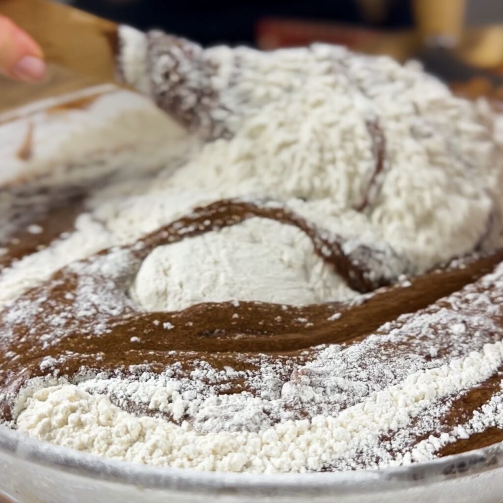 Folding flour into brownie batter