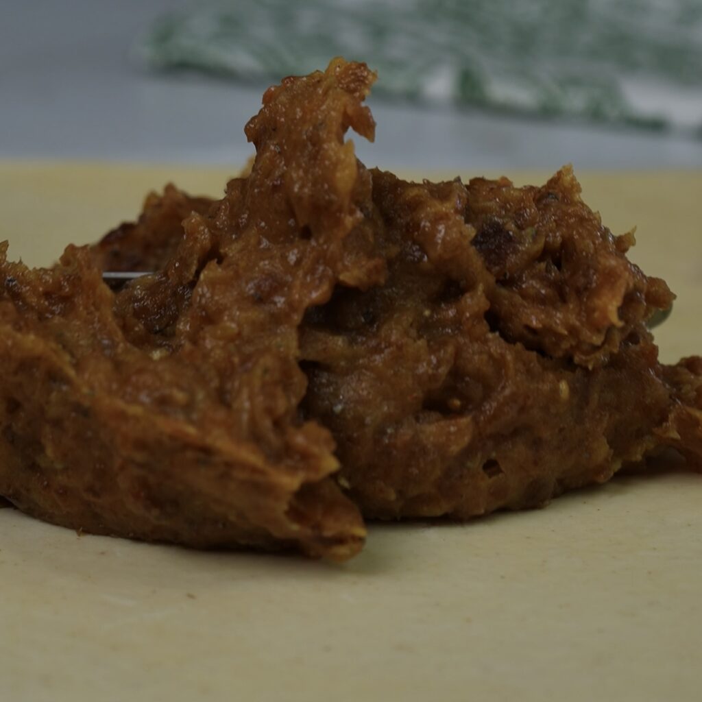 Spreading date and cardamom paste over puff pastry.