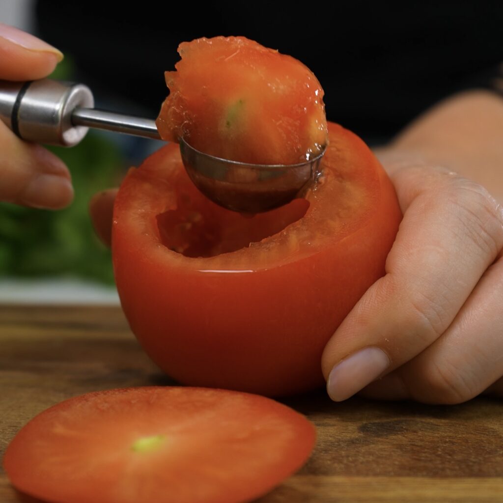 Scooping out tomato flesh