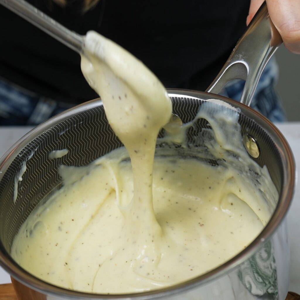 Ready béchamel sauce in a saucepan.