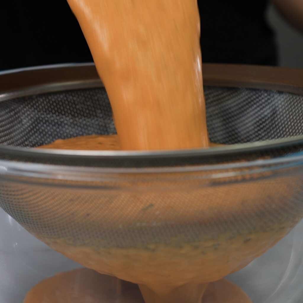 Straining blended roasted tomato soup