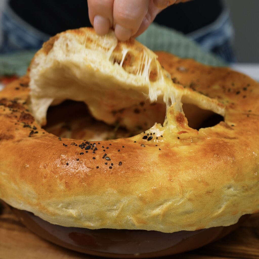 Creamy roasted tomato soup with mozzarella pastry crust, ready to serve.