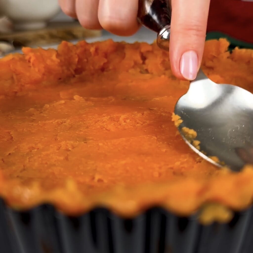 Sweet potato pressed firmly into a tart tin