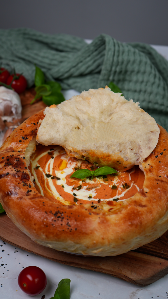 Creamy roasted tomato soup with mozzarella pastry crust.