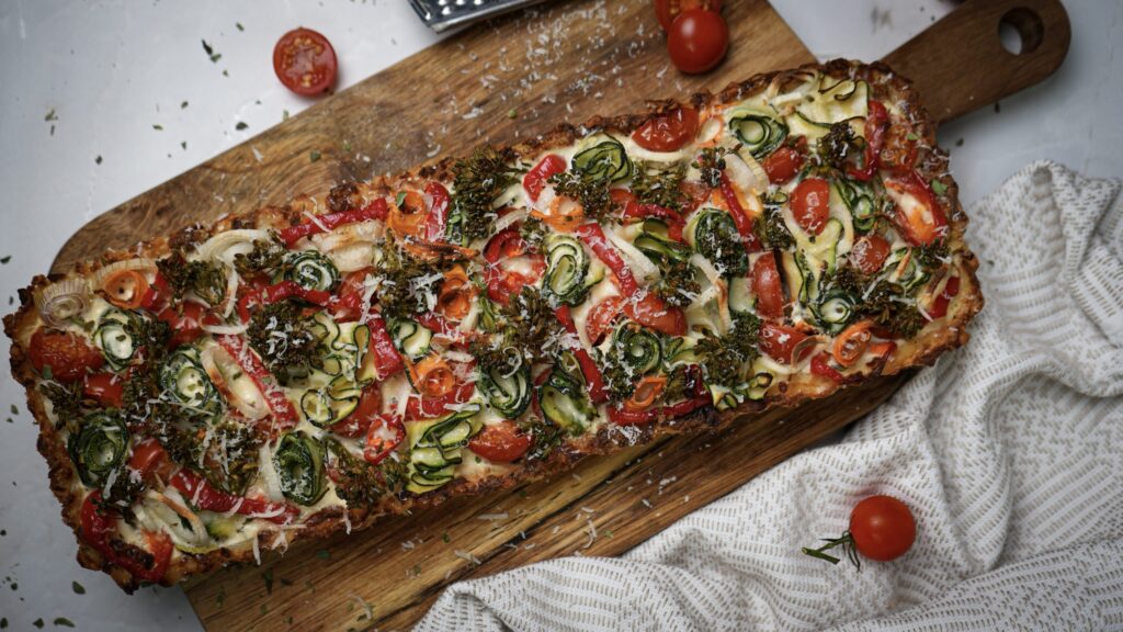 Crushed Potato Veggie Quiche with a golden crust and colourful vegetable filling.