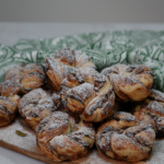 Date and Cardamom Swirl Buns dusted with icing sugar.