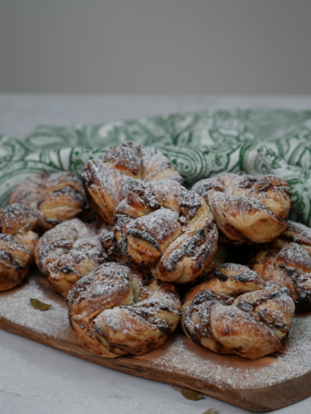 Date and Cardamom Swirl Buns dusted with icing sugar.