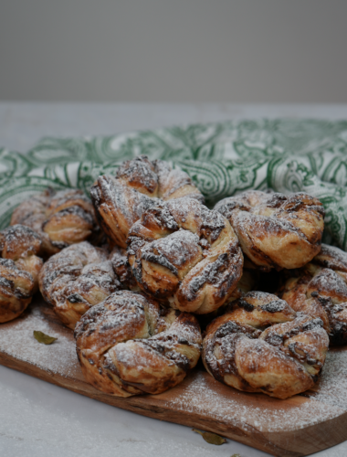 Date and Cardamom Swirl Buns dusted with icing sugar.