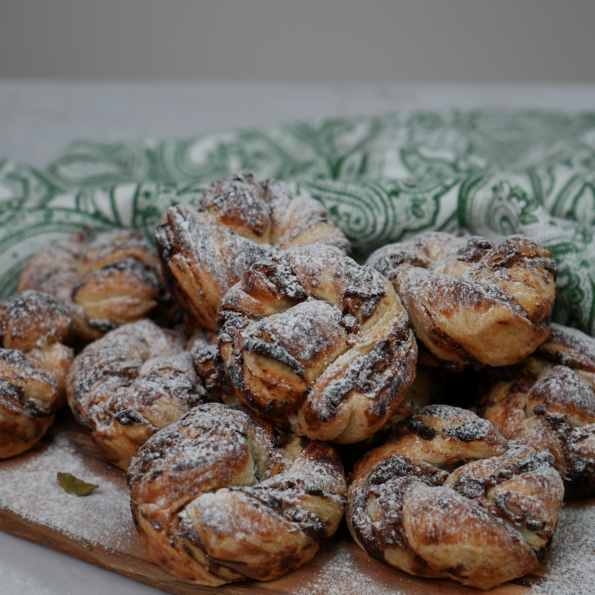 Date and Cardamom Swirl Buns dusted with icing sugar.