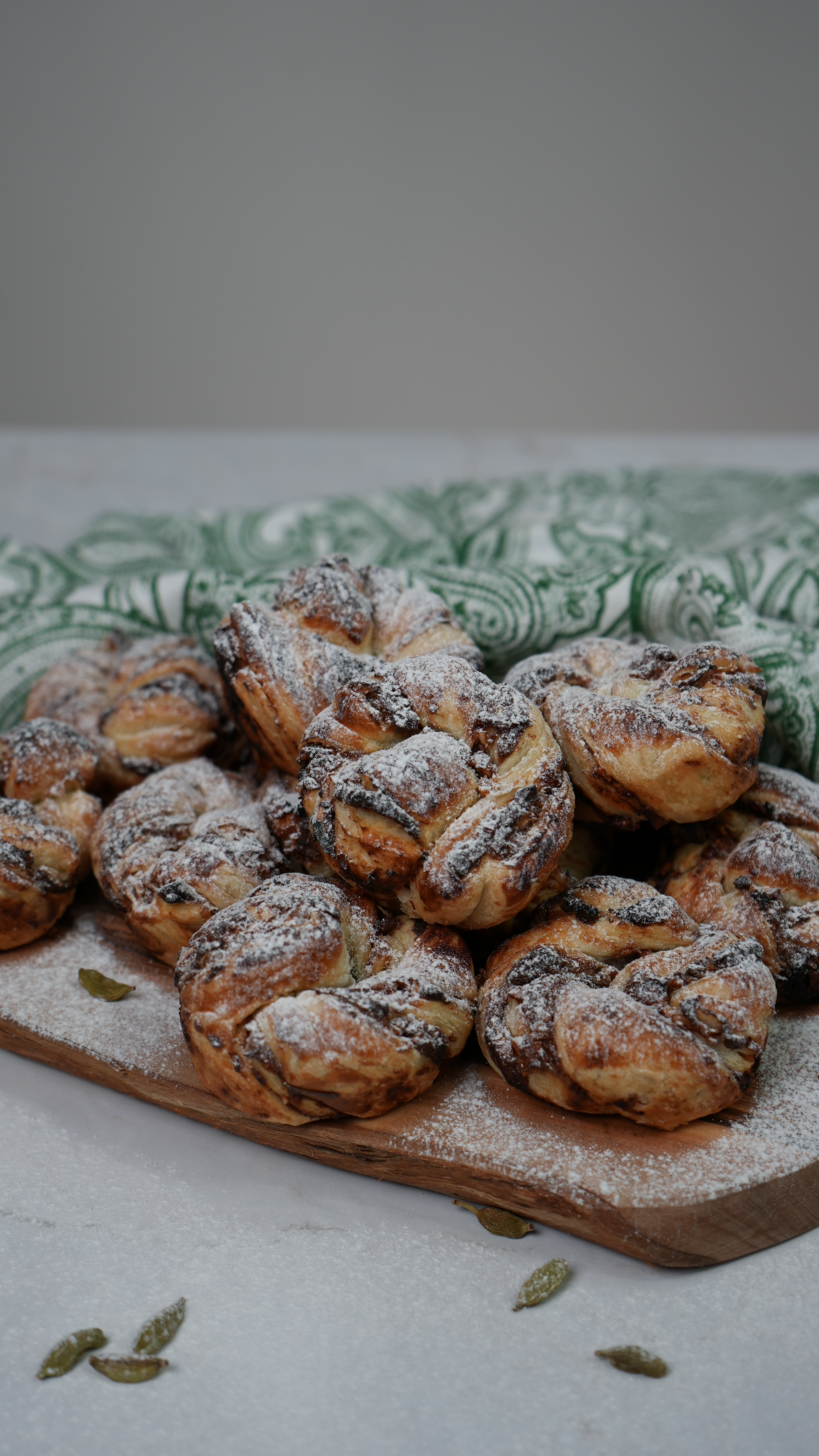 Date and Cardamom Swirl Buns dusted with icing sugar.