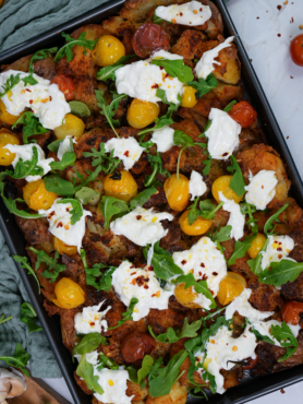 Loaded Crushed Potatoes with roasted tomatoes, fresh rocket, and torn burrata.