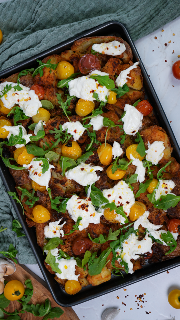 Loaded Crushed Potatoes with roasted tomatoes, fresh rocket, and torn burrata.