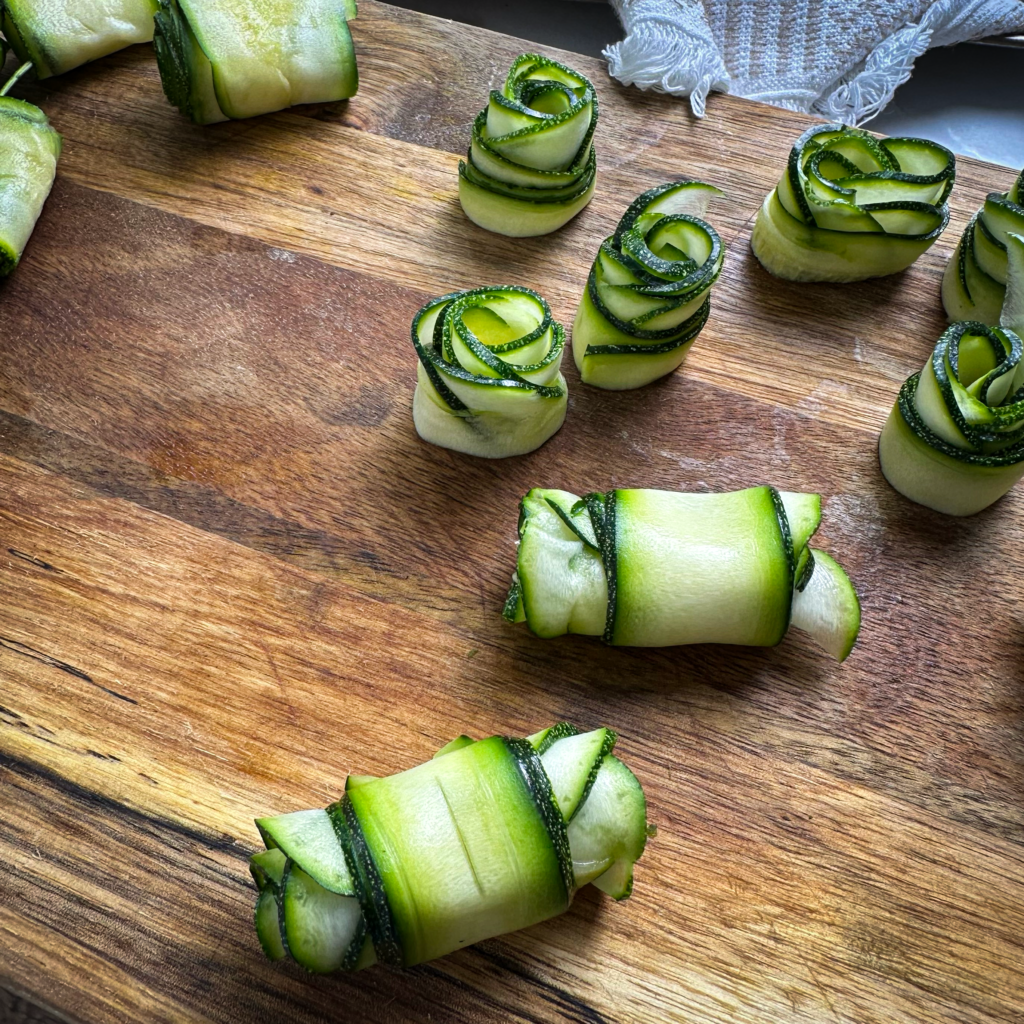 Courgette slices and strips beautifully rolled into rose shapes, ready for the Crushed Potato Veggie Quiche.