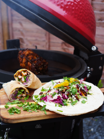 Chicken Shawarma served with pita and fresh vegetables, cooked on a Kamado Joe grill.