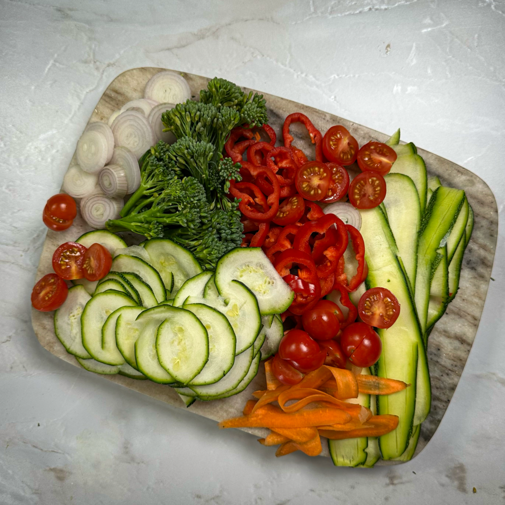 Freshly sliced vegetables arranged on a cutting board.